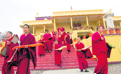 Tibetan monks come out the Kirti monastery after their morning prayers at Sidhbari near Dharamsala