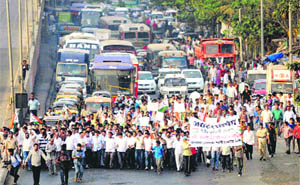 NCP activists block the Borivali Western Express Highway to protest against the attack on party president Sharad Pawar, in Mumbai on Thursday.