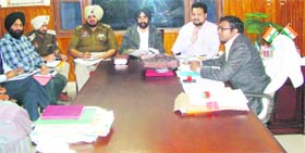 ECIL officials discuss the process for checking EVMs at the DCs office in Ferozepur