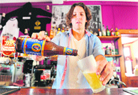 A barman pours a glass of Foster's beer at the Drop Bear Inn in South Melbourne on Friday. Australia's government approved brewer SABMiller's US $11.2 billion takeover of 150-year-old Foster's, but with strict conditions. 