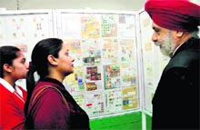 Visitors take a look at stamps during an exhibition at Sector 17 in Chandigarh