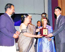 Governor Margaret Alva presents the AFII Josephite of the Year award to John Antony in Dehradun on Friday