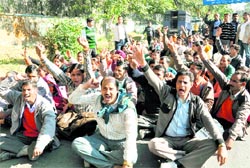 BTC trained Shiksha Mitters stage a dharna on a road leading to the residence of the Uttarakhand Chief Minister in Dehradun on Friday