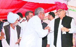 Chief Minister Bhupinder Singh Hooda meets a voter during his campaign at Ratia on Friday