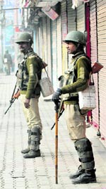 Securitymen stand guard during a strike in Srinagar on Friday