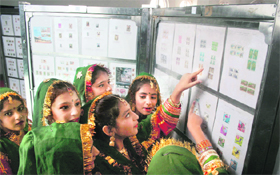 Girls look at stamps during the four-day philatelic exhibition and post office festival, Jammu Stamp Show-2011 organised by the Jammu and Kashmir Postal Circle at Kala Kendra in Jammu.