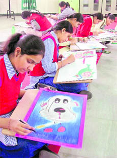 Students participate in a poster-making competition at Green Land School at Dugri in Ludhiana.