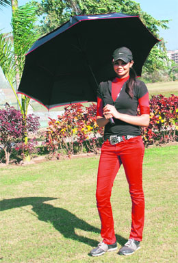With nine piercings on her ears, streaked hair, and a Tiger Woods umbrella, model-cum-golfer Sharmila Nicollet carries as much chutzpah on the course as on the catwalk. Photos: Nitin Mittal