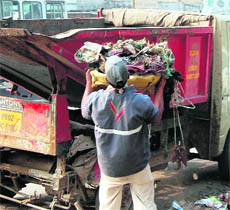 A worker collects garbage in Amritsar on Saturday.