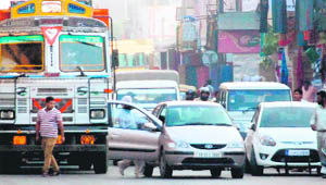Improper parking of vehicles on the highway leads to a traffic jam near Zirakpur flyover.