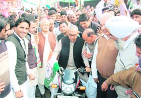 Chief Minister Bhupinder Singh Hooda rides a motorcycle in Ratia on Saturday