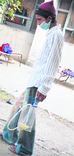 A patient walks with his urine bag.