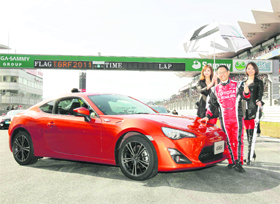 Toyota Motor Corp president & CEO Akio Toyoda unveils a production prototype of the '86' compact rear-wheel drive sports coupe at the Fuji Speedway in Oyama, central Japan, on Sunday. The car is designed to inject some sportiness into the brand and bolster an image damaged by a series of setbacks over the past three years. Developed jointly with Subaru, a unit of Fuji Heavy Industries Ltd, the vehicle will arrive in showrooms in the US and Japan in spring. Toyota declined to provide the name of the U.S. version, but it will be sold in the Japanese market as the Hachiroku. 