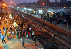 Passengers wait for their trains at the Bathinda railway station on Sunday