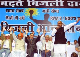 BJP leaders raise hands during a rally to protest against the decision of the Delhi government to raise the power tariff in New Delhi on Sunday