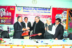 Officials of the Dolphin (PG) Institute of Biomedical Sciences sign an MoU with the Industries Association of Uttarakhand in Dehradun on Saturday. 