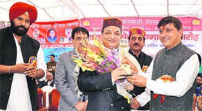 Rajinder Rana, president of the Sarva Kalyankari Sabha, confers the Himachal Rattan Award on Dr Raj Bahadur, Director, Government Medical College, Chandigarh, at a function in Sujanpur Tihra on Sunday. A Tribune photograph