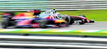 Red Bulls Sebastian Vettel (L) overtakes Jenson Button of McLaren at the Interlagos racetrack in Sao Paulo during the qualifying session for the Brazil GP on Saturday
