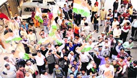 Congress supporters cheer their leaders outside the DC office