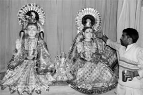 A priest indicates towards idols without silver crowns at a temple in Sector 12-A of Panchkula on Monday