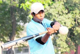 Mohit of Chandigarh swings at the ball during a softball game on PEC University campus in Chandigarh on Monday