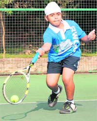 Chiraz Singh returns a shot during the under-12 final match against Navneet Singh at Chandigarh Club on Monday. Chiraz won the match 6-1, 6-0