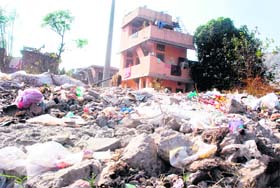 Garbage dumped near a residential area at Indira Colony