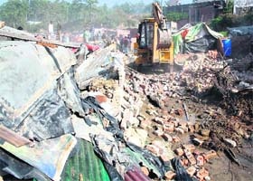 An anti-encroachment drive under way by the Dehradun Municipal Corporation at Brahmawala Khala on Monday