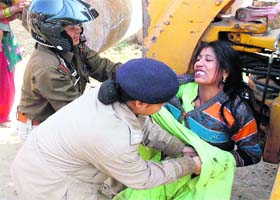 A woman resident resists the drive