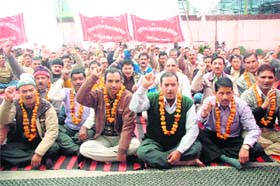 Employees of the Uttarakhand Forest Development Corporation hold a dharna in support of their demands in Dehradun on Monday
