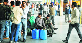 Commuters stranded at the bus stand following a strike by the Punjab Roadways and Punsup contractual staff in Ludhiana on Monday. 