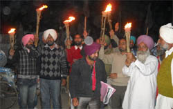 Teachers holding a candlelight protest march in Buttar Bakhuha village of Gidderbaha 
