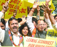 Activists of BJP investor cell shouting slogans during their protest against the UPA government in New Delhi on Tuesday. 