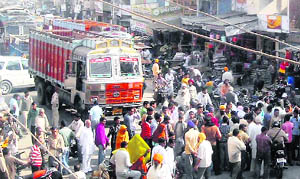 Agitators block Karnal-Kaithal road against the murder of a youth at Nissing in Karnal on Tuesday. 