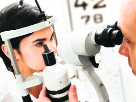 A doctor examining the eyes of a patient