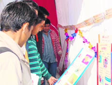 Youth visit an HIV/AIDS awareness exhibition organised by the Red Ribbon Club during a college fest at Rait. 