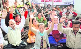 Members of the J&K Home Guards Welfare Association hold a protest in Jammu on Tuesday