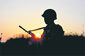 A BSF jawan stands guard on the international border in the Kanachak area of Jammu.
