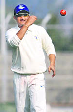 Bengals captain Sourav Ganguly throws a ball during their Ranji Trophy match against Haryana in Rohtak