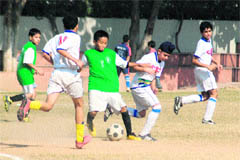 Players of St Stephens School and St Johns High School vie for the ball during the Chandigarh Sub-Junior Football Tournament for boys at St Kabir School, Sector 26, Chandigarh