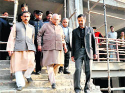 Uttarakhand Assembly Speaker Harbans Kapoor (centre) comes out of the new shopping complex being built to accommodate Chakrata Road shopkeepers in Dehradun