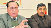 NP Diwan (left), president, Pradesh Udyog Vyapar Mandal Samiti, addresses a press conference in Dehradun