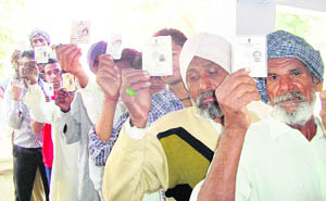 Villagers queue up outside a polling booth in a Ratia village, where a heavy turnout was reported in the bypoll on Wednesday