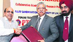 Vice-Chancellor of Punjab Technical University Dr Rajneesh Arora and his counterpart from Rajiv Gandhi National University of Law Patiala Dr Paramjit Singh Jaswal sign an MoU in Jalandhar