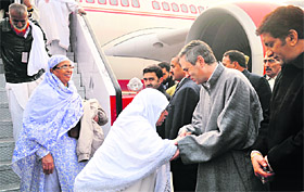 Chief Minister Omar Abdullah receives the first batch of Haj pilgrims, which arrived at Srinagar Airport on Wednesday. Photo: Amin War