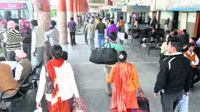 Commuters wait in vain for mini-buses that were engaged to ferry people to an SAD function at Chappar Chiri in Mohali on Wednesday
