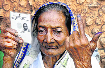 An octogenarian voter shows her voter ID card after casting her vote in Kolkata on Wednesday.  PTI