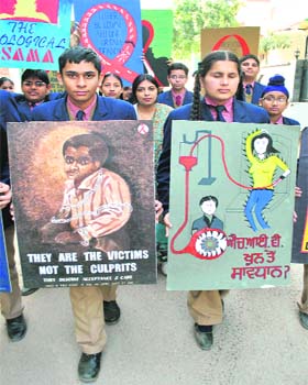 Schoolchildren hold an awareness rally on the eve of the World AIDS Day in Patiala, on Wednesday