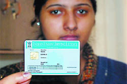 A staff shows a blank smart card driving licence at the printing laboratory in the office of District Transport Officer in Bathinda on Thursday