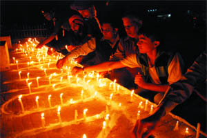 Residents light the candles on the occasion of the World AIDS Day at Bathinda railway station on Thursday evening. 